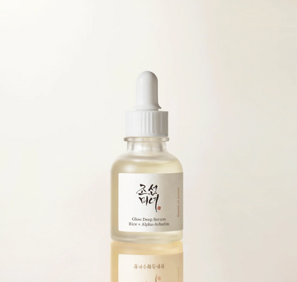 Skincare serum bottle with dropper on a light beige background