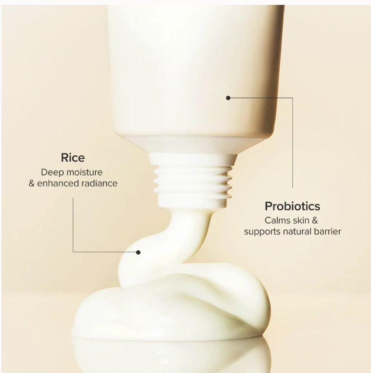 Cosmetic bottle with text highlighting rice and probiotics benefits on a beige background