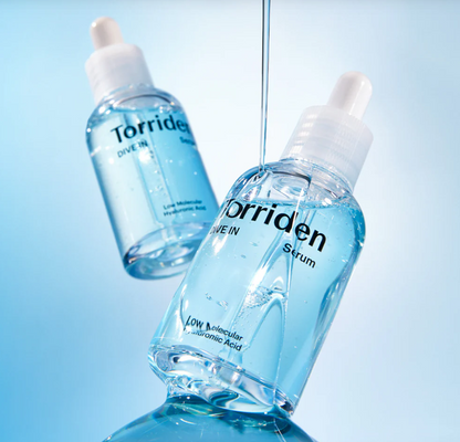 Two bottles of Torriden serum on a light blue background